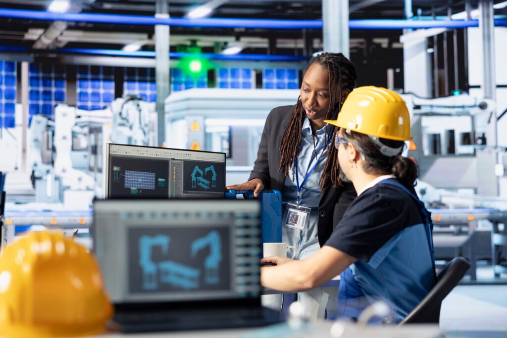staff members in photovoltaics factory reviewing system logs